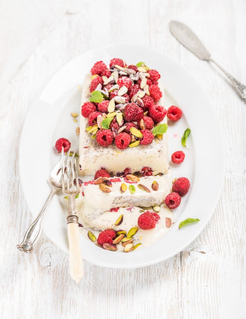 Homemade semifreddo with pistachio and fresh raspberries