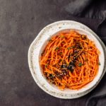 Raw carrot noodles or spaghetti, top view